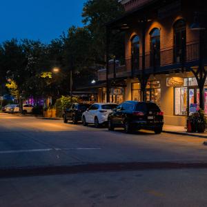 Downtown lights shining along the sidewalk.