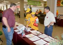Monroe County Extension agent Randall Nevins, left, reviews horticulture career options with Karen Carothers and Elsie Buskes, both of Oxford, Mississippi. Dennis Reginelli, right, a regional specialist with the Mississippi State University Extension Service, joins the discussion at a career expo for eighth-graders in Tupelo, Mississippi, on Oct. 5, 2016. (Photo by MSU Extension Service/Linda Breazeale)