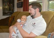 Boone Purser enjoys afternoon cuddles with his son, Benji, on Oct. 31, 2016. Benji is a breastfed baby who thrives on attention from both his parents at his home in Starkville, Mississippi. (Photo by MSU Extension Service/Linda Breazeale)