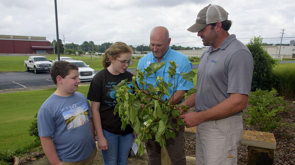 Two MSU Extension agronomy specialists instruct youth campers.