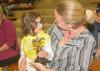 Nora Molina, 5, is proud to show her horseback riding trophy to her teacher Leslie Earnest, a research associate at the T.K Martin Center at Mississippi State University. Molina was one of 46 riders taking part in the second annual Therapeutic Riding Expo at the Mississippi Horse Park on April 19, 2016. (Photo by MSU Extension Service/Linda Breazeale)
