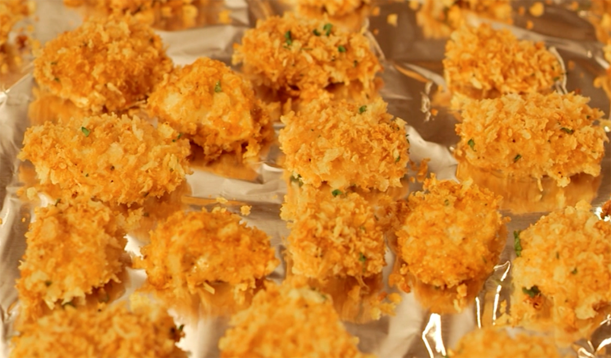 Chicken nuggets on a foil-lined sheet pan.