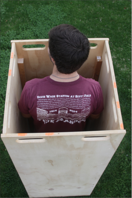 Shot taken from above a man standing inside a plywood coffer dam.