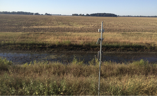 TWR ditch in fall (October) The surrounding grass is mostly brown and the ditch is full of water.