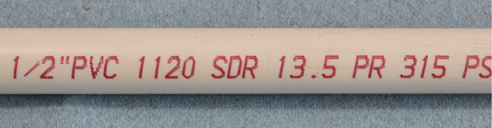 PVC pipe with specifications printed on it: 1/2 inch, 1120, SDR, 13.5, PR, 315, PS.