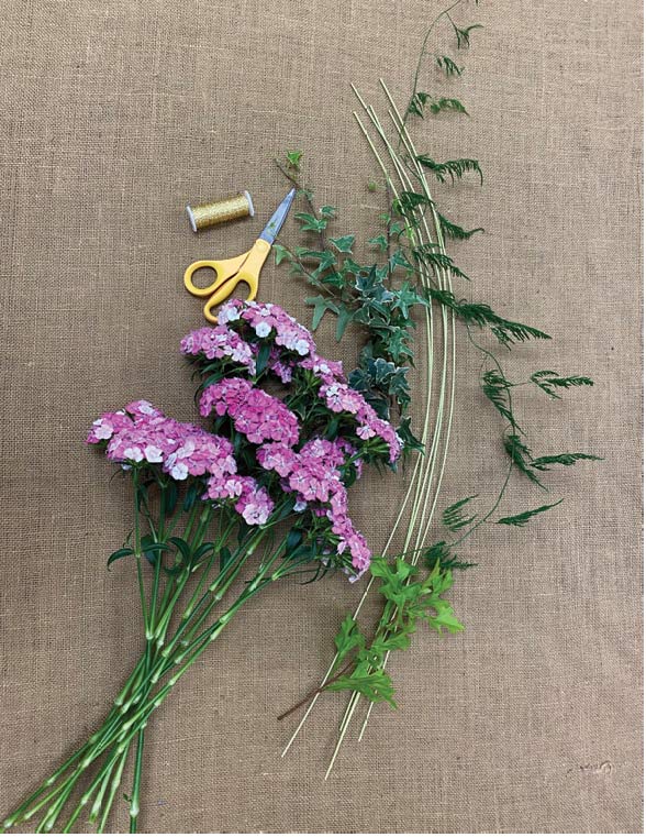 Materials necessary for a full dianthus bouquet including dianthus stems, bullion wire, floral shears, ivy, oak stem, midollino sticks and plumosa.