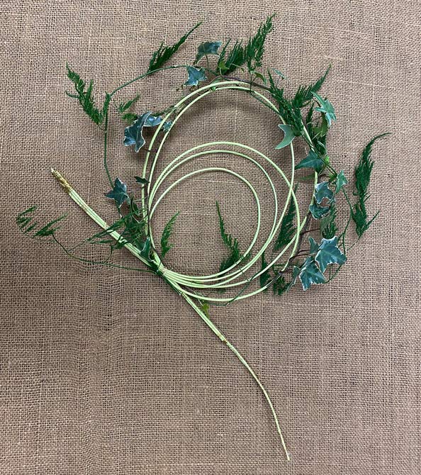 Bullion wire folded into large loop for support of dianthus bouquet. The loop is decorated with a bit of ivy for added flair.