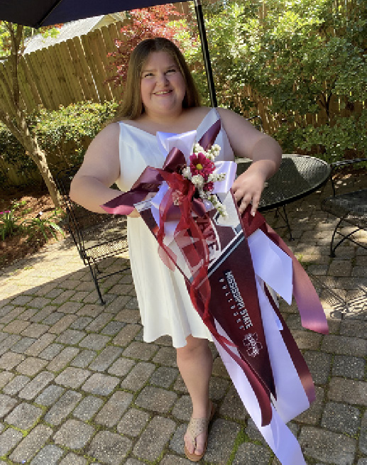 A young woman shows off a fully decorated pennant.