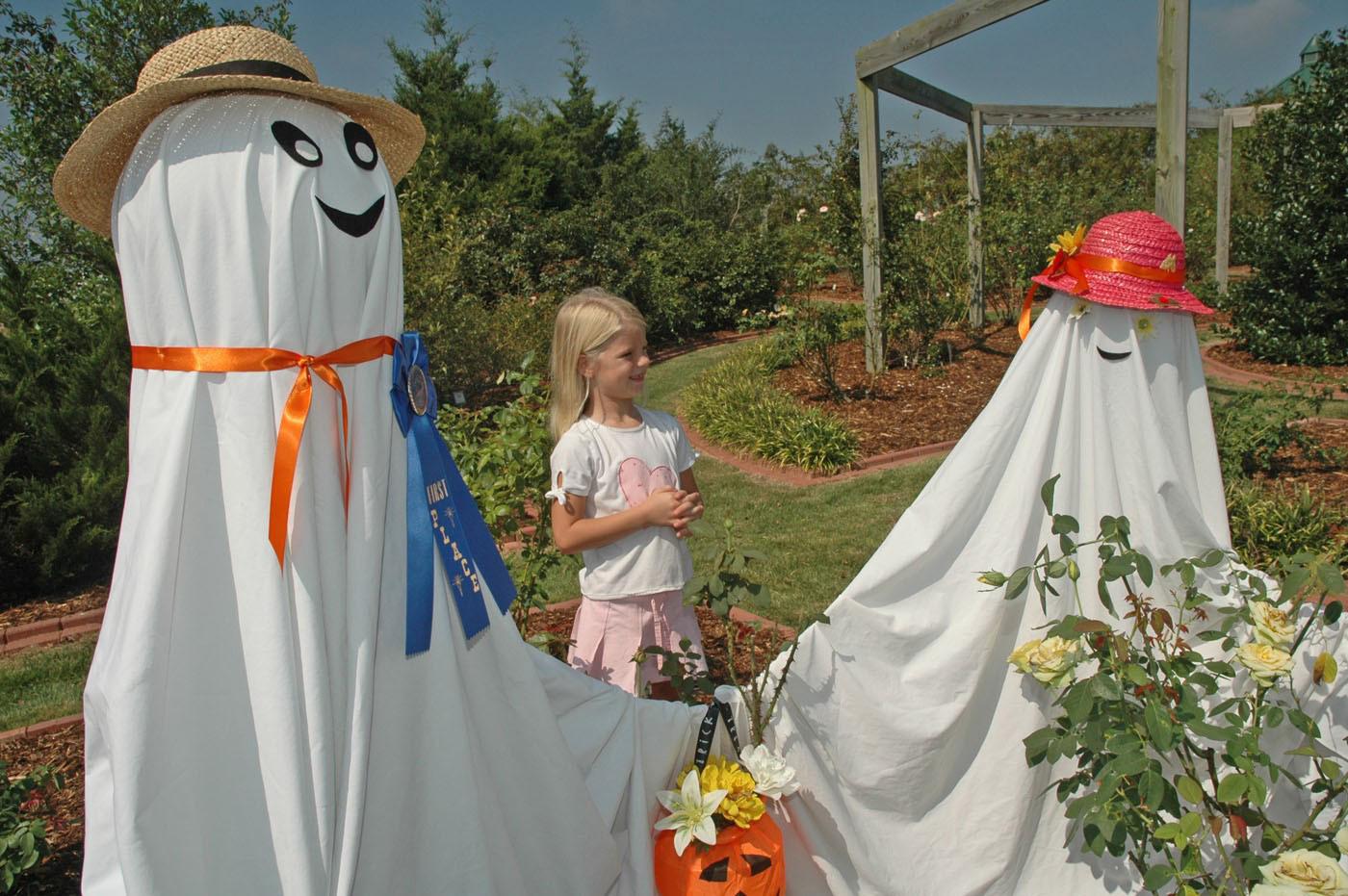 Sidney Dobbs of Hamilton enjoys a visit with some of the ghostly residents of the Scarecrow Trail. The trail winds through the gardens at the North Mississippi Research and Extension Center in Verona and is open to the public on weekdays through Oct. 25. 