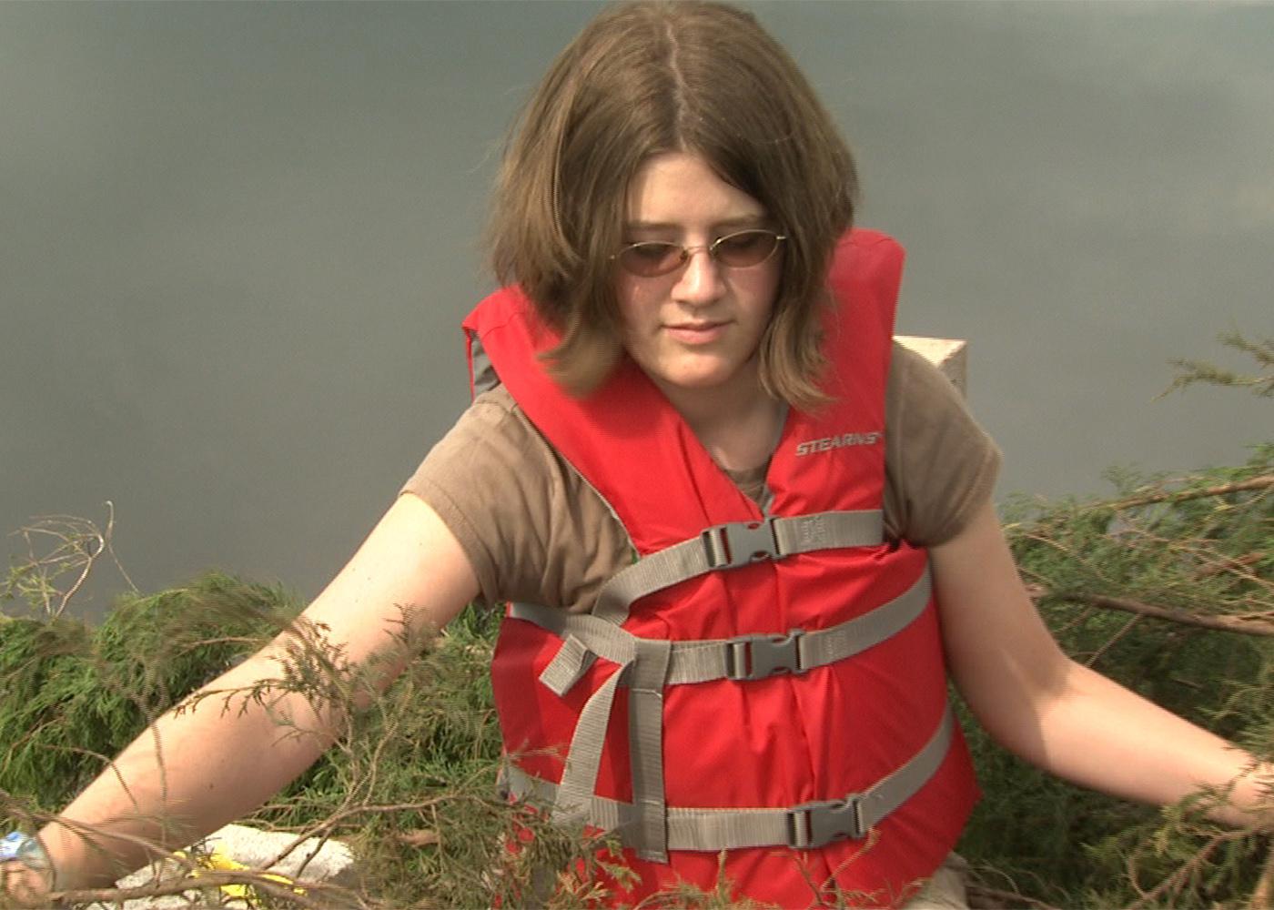 Kiln native Dana Reppel, 13, learns to build fish attractors from old Christmas trees during conservation camp at Mississippi State University this summer. She and other youth helped sink the trees into Oktibbeha County Lake. (Photo by Artis Ford)