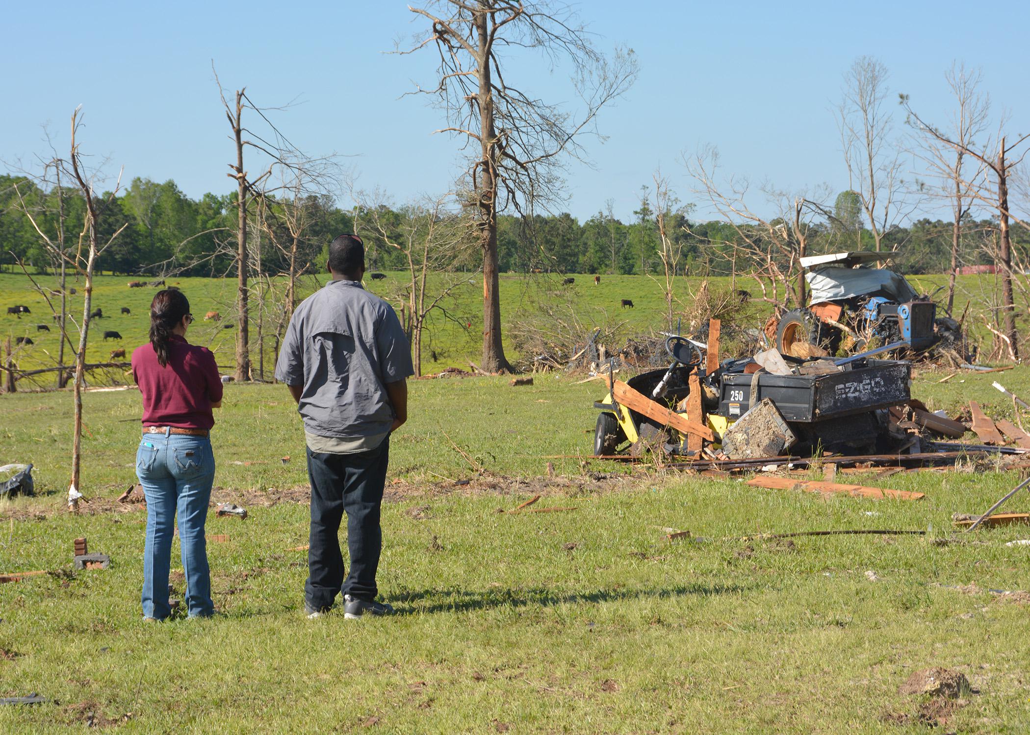 A specialist with the Mississippi State University Extension Service surveys agricultural damage with a Winston County resident following the tornado that hit on April 28, 2014. A grant will enable Extension to re-evaluate disaster efforts in communities across the state. (File photo by MSU Ag Communications/Linda Breazeale)