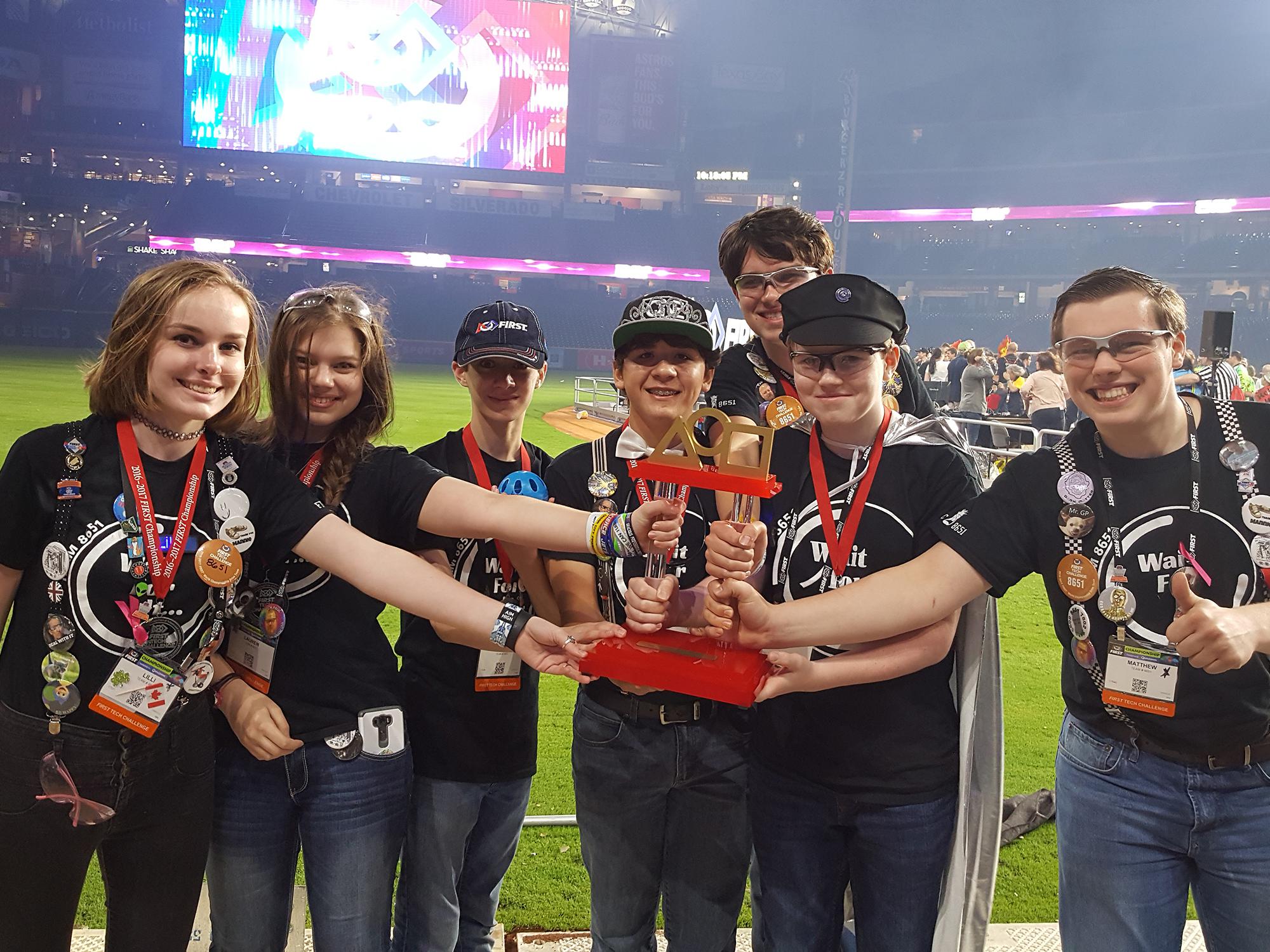 The Rankin County 4-H robotics team, Wait For It, was in the winning alliance of three teams at the FIRST Tech Challenge in Houston, Texas. Members Lilli Stewart, left, Lauren Blacksher, Noah Gregory, Maisyn Barragan, Jordan Hariel, Logan Hariel and Mathew Blacksher are on the playing field of Minute Maid Park in front of 25,000 people to receive their award on April 22, 2017. (Submitted Photo)