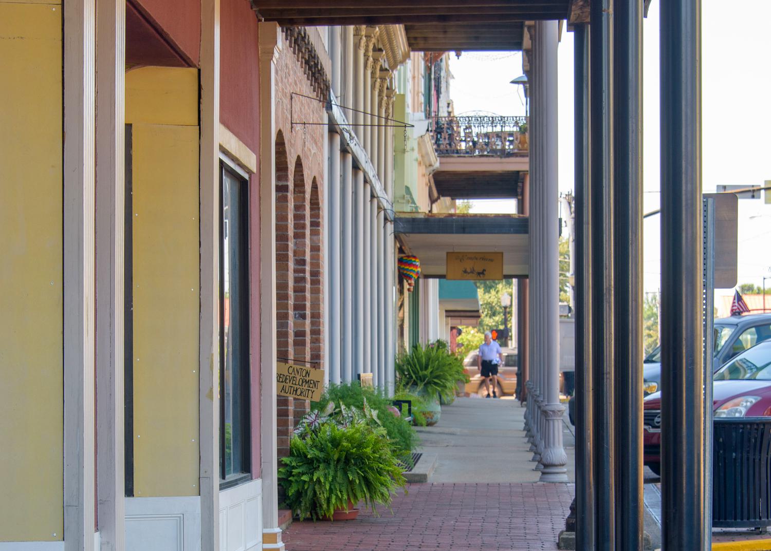 A view down a covered downtown sidewalk.