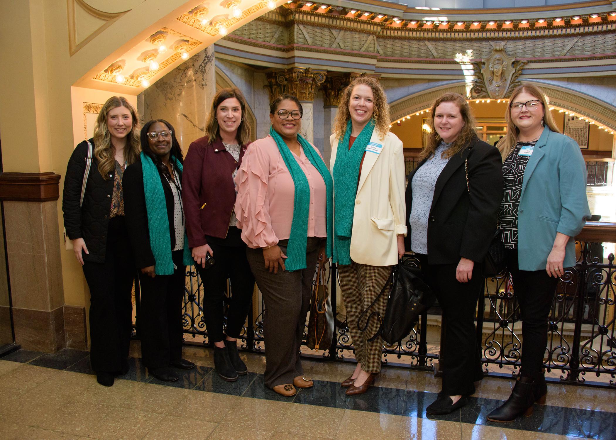 Seven women stand in the Mississippi State Capitol building.