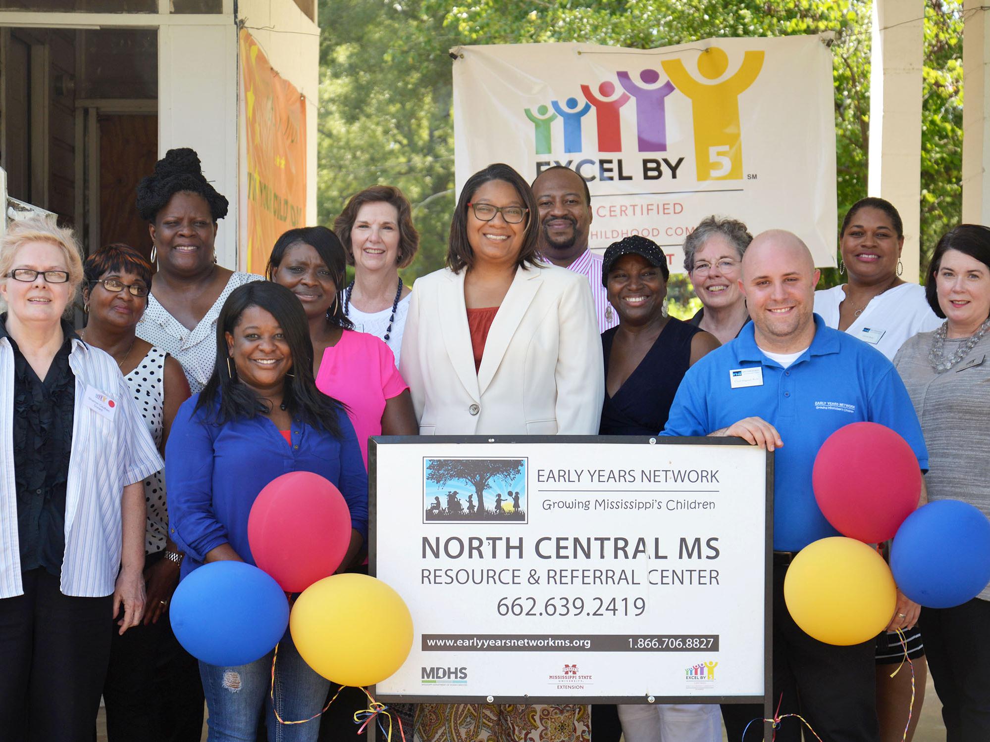 Members of Mississippi State University Extension Service, the Early Years Network and Excel by 5 celebrated the grand opening of the North Central Mississippi Resource and Referral Center with Durant Mayor Tasha Davis (center) and community members on Aug. 2, 2016. The center provides early child care educators, families and other residents in Holmes County a place to visit and borrow educational books, toys and games. (Photo by MSU Extension Service/Alexandra Woolbright)