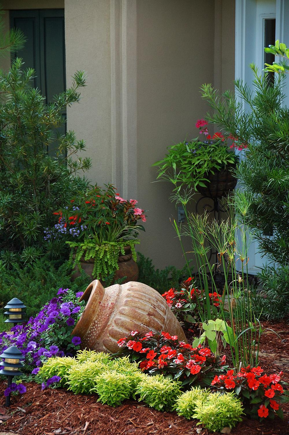 SunPatiens Vigorous Orange is planted behind lime green Joseph's coats, setting off the Blue Wave petunias spilling out of a container. (Photos by Norman Winter)