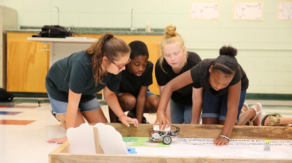 4 children with robot vehicle.