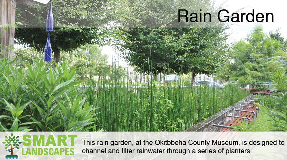 Lush rainwater irrigated planter bed with a seating wall at the Oktibbeha County Museum