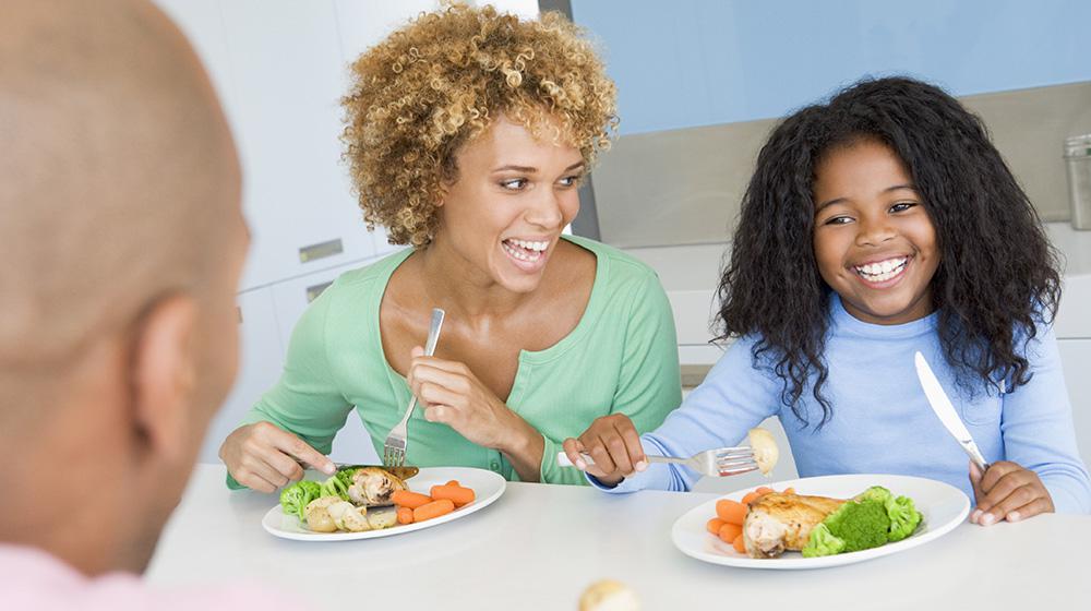 Family eating meal at table.