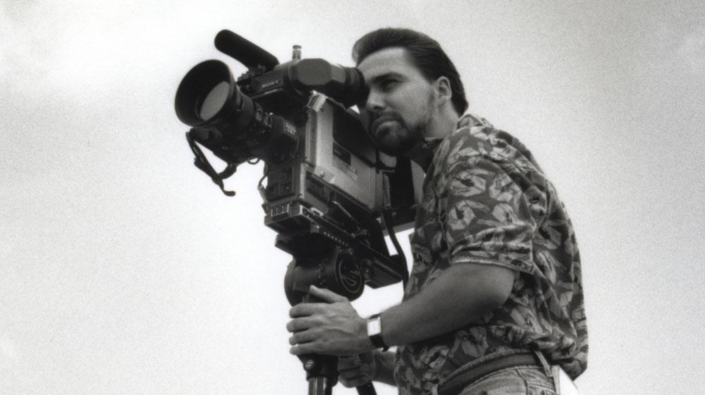 Man using an old television camera.