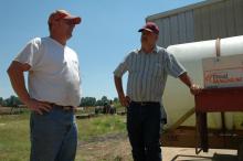 Farming award winner John Ingram, left, visits on his farm with Yalobusha County Extension Director Steve Cummings one early summer day. Both men are among several Yalobusha County residents to earn recognition for their work in agriculture.