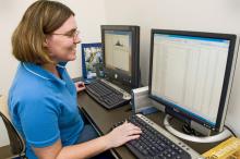 Fiona McCarthy, a biocuration specialist with the Mississippi State University College of Veterinary Medicine, examines protein expression data that may indicate how the immune system develops in chickens. (Photo by Tom Thompson)