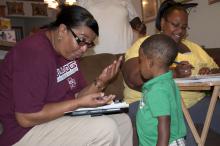 Margie Moore, left, with the Mississippi Child Care Resource & Referral Network's Project Navigator, reviews educational materials with Sherris and Curtis Grace of DeKalb.