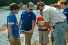 Daryl Jones, an associate Extension professor in Mississippi State University's Forest and Wildlife Research Center and Newton County Middle School student Scott Round look at the catfish Round caught during the Youth Fishing Day at MSU's Coastal Plain Branch Experiment Station in Newton, a branch of the Mississippi Agricultural and Forestry Experiment Station. (Photo by MSU Ag Communications/Susan Collins-Smith) Newton County Middle School students Gavin Bailey (from left), Peyton Chaney and Dylan Barnett 