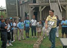 Kyle Lewis, county agent with Mississippi State University's Extension Service in Hinds County, explains the life cycle of corn to Bates Elementary School students during AgVentures. The event was sponsored by the Extension Service and held April 16 and 17 at the Mississippi Agricultural and Forestry Museum in Jackson. (Photo by MSU Ag Communications/Susan Collins-Smith)