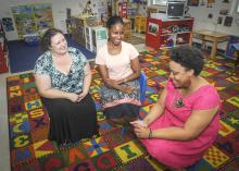 Mississippi State University faculty Lori Elmore-Staton and MSU Extension Service family life specialist Cassandra Kirkland discuss sleep strategies with Santee Ezell of Starkville at a family health workshop hosted by the Brickfire Project. (Photo by MSU Ag Communications/Scott Corey)