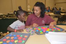 Four-year-old Mairah Haynes enjoys activities provided by Shandra Hurd, a Mississippi State University Extension Service staff member with the Mississippi Child Care Resource and Referral Network, on May 1, 2014. Haynes and her family relocated to the American Red Cross Shelter at First Baptist Church in Louisville, Mississippi, following the April 28 tornado. (Photo by MSU Ag Communications/Linda Breazeale) 