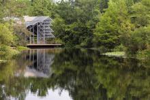 The Pinecote Pavillion stands in the background of the pond at the Crosby Arboretum.