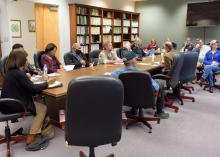 A group of people sitting around a table.