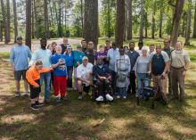 A group gathers for an outdoor photo.