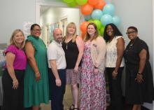 People pose for a photo during an open house event.