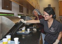 Doctoral student Yan Campbell, front, and research associate Vi Jackson serve trays to consumer panelists, who evaluate the food samples and determine how acceptable they are. (Photo by MSU Extension Service/Kat Lawrence)