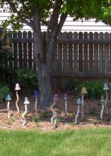 This ceramic mushroom patch  is surrounded by beautiful Apricot Beauty tulips in the spring and flowering annuals, such as marigolds, later in the year.