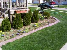 Landscape pavers can be set into the ground to allow mower wheels to run over them, making a neat landscape edge that requires no trimming. (Photos by Gary Bachman)