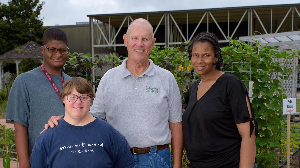 John Malanchak, center, with, from left, Roderick Benson, Megan Schmidt, and Latangelia Bolden. Master Gardener volunteer and gardening participants.