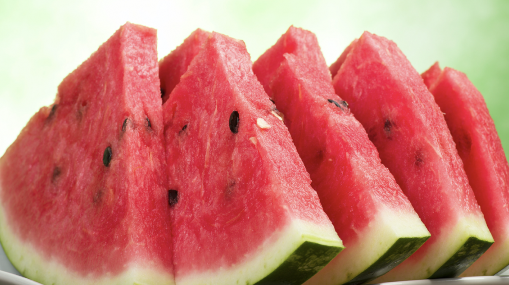 Close up of triangular watermelon slices on a plate.