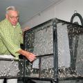 Frank Davis displays one of the large cages developed for holding adult southwestern corn borer moths at the U.S. Department of Agriculture's Agricultural Research Service facility in Starkville. (Photo by Linda Breazeale)