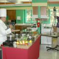 Mississippi State University Extension Service distance education coordinator Susan Seal runs the video camera while MSU chef Roland Parny demonstrates cooking techniques during a recent Quick Bites program. (Photo by Bob Ratliff)