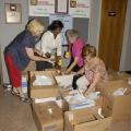 Mississippi Extension office associates Joyce Thompson of Oktibbeha County, Barbara Curry of the Northeast District office, Mary Minor of Marshall County and Colleen Butler of Scott County sort through hundreds of food items collected during their 2009 state meeting. (Photo by Linda Breazeale)