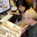 Experts at the Mississippi Entomological Museum manage the moth photographers' group website, the largest collection of moth images in the world. Here, museum director Richard Brown and Mississippi State University entomology researcher SangMi Lee compare moth samples to the images posted on the website. (Photo by Kat Lawrence)