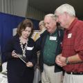 Mariah Smith (left), Extension computer applications instructor, discusses the iPad and its use in agricultural production with Art Waymire (center), a tree farmer from Marshall County, and Tony Campbell, a cotton and soybean farmer from Itawamba County. (Photo by Scott Corey)