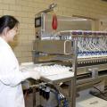 Wei Zhai, assistant Mississippi State University Extension poultry science professor, uses a multi-egg injector machine to inject eggs with carbohydrates. (Photo by Kat Lawrence)