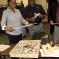 Oktibbeha County 4-H Advisory Council President Angela Burress Stewart, a volunteer leader with the Longview Disciples 4-H Club, is the recipient of the salute to excellence volunteer of the year award from Mississippi 4-H. She and council member Victor Evans, both of Starkville, review insect collections and other items going to the 2011 State Fair in Jackson. (Submitted photo)