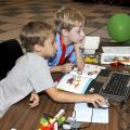 Ethan Hicks and Eric Mellin of Starkville follow instructions to program the soccer goalie robot they built at the Cloverbud Camp held at Mississippi State University. (Photo by MSU Ag Communications/Scott Corey)