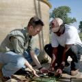 Mississippi State University assistant professor and aquatic scientist Peter Allen, left, and doctoral student Daniel Aboagye examine an alligator gar near the outdoor tank facilities at MSU's Aquaculture Facility. (Photo by MSU Ag Communications/Kat Lawrence)