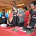 Terri Thompson, Jackson County Extension family and consumer sciences agent (from left); Jennifer Williams, Webster County Extension family and consumer sciences agent and Cassandra Kirkland, Extension family life specialist, cook ground beef during a demonstration at a professional development session held in Jackson on July 16, 2013.  (Photo by MSU Ag Communications/Susan Collins-Smith)